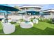 Outdoor entertainment area with turf, umbrellas, and games at 3282 E Palo Verde Dr, Paradise Valley, AZ 85253