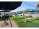 Outdoor entertainment area with turf, umbrellas, and games at 3282 E Palo Verde Dr, Paradise Valley, AZ 85253
