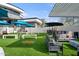 Outdoor entertainment area with turf, umbrellas, and games at 3282 E Palo Verde Dr, Paradise Valley, AZ 85253
