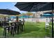Outdoor entertainment area with turf, umbrellas, and games at 3282 E Palo Verde Dr, Paradise Valley, AZ 85253
