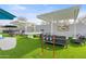 Outdoor entertainment area with turf, games, and pergola at 3282 E Palo Verde Dr, Paradise Valley, AZ 85253