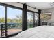 Modern bedroom with sliding glass doors leading to scenic views and a flat-screen TV at 3282 E Palo Verde Dr, Paradise Valley, AZ 85253