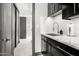 Modern butler's pantry with marble countertops and black cabinetry at 3282 E Palo Verde Dr, Paradise Valley, AZ 85253