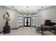 Elegant entryway with modern double doors, high ceilings, and a grand piano at 3282 E Palo Verde Dr, Paradise Valley, AZ 85253