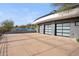 Three-car garage with modern glass doors and a spacious concrete area at 3282 E Palo Verde Dr, Paradise Valley, AZ 85253