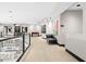 Long hallway with modern art, a foosball table, and a sleek couch at 3282 E Palo Verde Dr, Paradise Valley, AZ 85253