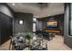 Modern indoor patio with a glass dining table and fireplace at 3282 E Palo Verde Dr, Paradise Valley, AZ 85253