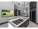 Modern kitchen island with marble countertop, gas cooktop, and built-in appliances at 3282 E Palo Verde Dr, Paradise Valley, AZ 85253