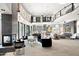 Open living area with a two-story high ceiling, fireplace and large windows at 3282 E Palo Verde Dr, Paradise Valley, AZ 85253