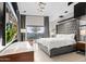 Spacious main bedroom with a gray upholstered bed and large TV at 3282 E Palo Verde Dr, Paradise Valley, AZ 85253