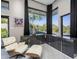 Modern home office with large windows, built in cabinetry and comfortable seating at 3282 E Palo Verde Dr, Paradise Valley, AZ 85253