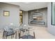 Outdoor patio with glass table, chairs, and fireplace at 3282 E Palo Verde Dr, Paradise Valley, AZ 85253