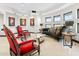 Elegant sitting area features a black velvet couch and ornate red chairs at 3282 E Palo Verde Dr, Paradise Valley, AZ 85253