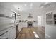 Modern white kitchen with stainless steel appliances and breakfast bar at 347 W Southern Hills Rd, Phoenix, AZ 85023