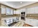 Granite countertop kitchen island with stainless steel appliances at 37415 N 24Th St, Phoenix, AZ 85086