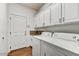 Laundry room with washer, dryer, and built-in cabinets at 37415 N 24Th St, Phoenix, AZ 85086