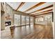 Spacious living room with hardwood floors, stone fireplace, and wood beams at 37415 N 24Th St, Phoenix, AZ 85086