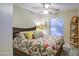 Bedroom with floral bedding and a window with blinds at 45061 W Alamendras St, Maricopa, AZ 85139