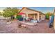 Relaxing patio featuring a table and chairs under an umbrella at 45061 W Alamendras St, Maricopa, AZ 85139