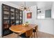 Mid-century modern dining room with wood table and glass cabinet at 4600 N 68Th St # 370, Scottsdale, AZ 85251