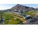 Aerial view of the community featuring modern homes, lush golf course, and mountain backdrop at 4849 N Camelback Ridge Dr # A101, Scottsdale, AZ 85251