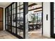 Modern dining room with large windows, wood beam ceilings, and stylish decor at 4849 N Camelback Ridge Dr # A101, Scottsdale, AZ 85251