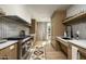 Modern kitchen with stainless steel appliances, light wood cabinets, and stylish design at 4849 N Camelback Ridge Dr # A101, Scottsdale, AZ 85251