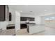 Modern kitchen with island, granite countertops, and dark cabinets at 5111 E Umber Rd, San Tan Valley, AZ 85143