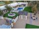 Aerial view of a luxurious estate with a pool, expansive lawn, and outdoor entertainment areas at 5817 E Leith Ln, Scottsdale, AZ 85254