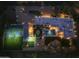 Night view of house and backyard amenities at 5817 E Leith Ln, Scottsdale, AZ 85254