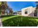 Expansive grassy backyard with partial view of home at 5817 E Leith Ln, Scottsdale, AZ 85254