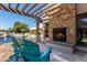 Relaxing backyard oasis with a sparkling pool, built-in fireplace, and pergola at 5817 E Leith Ln, Scottsdale, AZ 85254