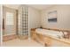 Bathroom with a large soaking tub and glass block shower at 5817 E Leith Ln, Scottsdale, AZ 85254