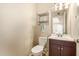 Small bathroom with toilet, sink, and vanity at 5817 E Leith Ln, Scottsdale, AZ 85254