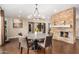 Bright dining room with stone fireplace and hardwood floors at 5817 E Leith Ln, Scottsdale, AZ 85254
