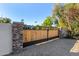 Custom wood and stone entry gate; adds to the curb appeal at 5817 E Leith Ln, Scottsdale, AZ 85254