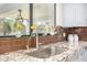 Kitchen sink with granite countertop and brown tile backsplash at 5817 E Leith Ln, Scottsdale, AZ 85254