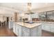 Large kitchen island with granite countertop and seating area at 5817 E Leith Ln, Scottsdale, AZ 85254