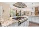 Granite island kitchen with gas cooktop and stainless steel appliances at 5817 E Leith Ln, Scottsdale, AZ 85254