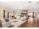 Spacious living room with stone fireplace, hardwood floors, and access to backyard at 5817 E Leith Ln, Scottsdale, AZ 85254