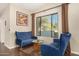 Cozy sitting area with two blue velvet sofas and ornate table at 5817 E Leith Ln, Scottsdale, AZ 85254