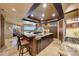 Open kitchen features granite island and breakfast bar at 6520 E El Sendero Rd, Carefree, AZ 85377