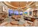 Lush living room with a stone fireplace, wet bar and scenic views at 6520 E El Sendero Rd, Carefree, AZ 85377