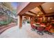 Covered patio with dining area and fireplace at 6520 E El Sendero Rd, Carefree, AZ 85377
