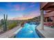 Expansive pool with waterfall feature; desert landscape at 6520 E El Sendero Rd, Carefree, AZ 85377