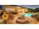 Backyard firepit with a view of the pool and home's exterior at 7034 E Soaring Eagle Way, Scottsdale, AZ 85266