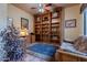 Charming office with wooden bookcase and comfy couch at 7034 E Soaring Eagle Way, Scottsdale, AZ 85266