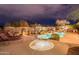 Night view of a luxurious pool and spa with lounge chairs at 7034 E Soaring Eagle Way, Scottsdale, AZ 85266