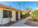 Light-beige building exterior with walkway, landscaping, and palm trees at 8241 N Central Ave # 11, Phoenix, AZ 85020