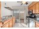Kitchen with granite countertops, stainless steel appliances, and wood cabinets at 8241 N Central Ave # 11, Phoenix, AZ 85020
